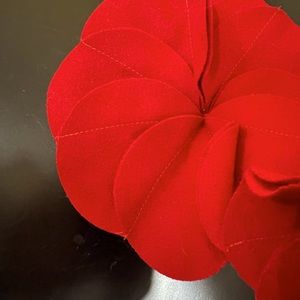 NWT GORGEOUS red wool scarf w/poinsettia floral design. Satin lined at”neckline